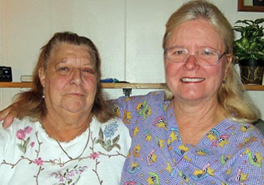 Nurse with arm around patients shoulder