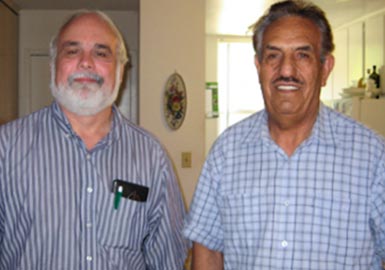 Two men inside a home